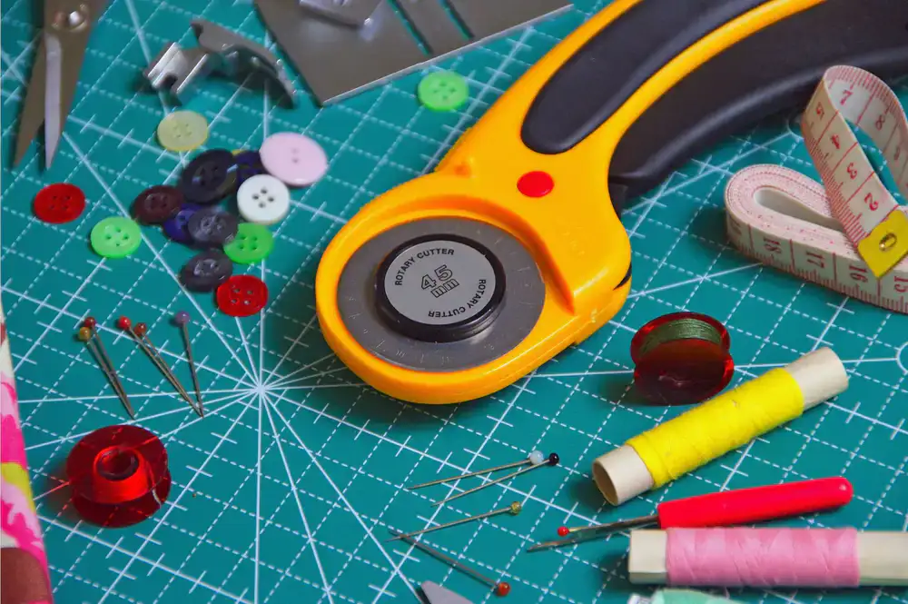 High quality fabric scissors, pins, and measuring tape on a cutting mat