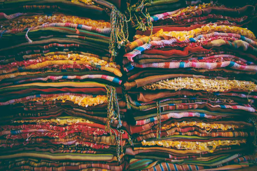 Vibrant stacks of folded fabric on a shop table